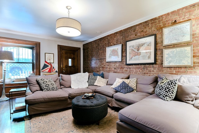 living area with crown molding, brick wall, and wood finished floors