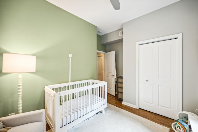 227 Christopher Columbus Dr Unit B-234, Jersey City, NJ 07302 - bedroom featuring wood finished floors, a crib, a closet, and a ceiling fan