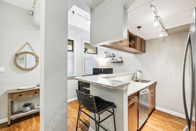 227 Christopher Columbus Dr Unit B-234, Jersey City, NJ 07302 - kitchen with appliances with stainless steel finishes, rail lighting, open shelves, light wood-type flooring, and light stone countertops