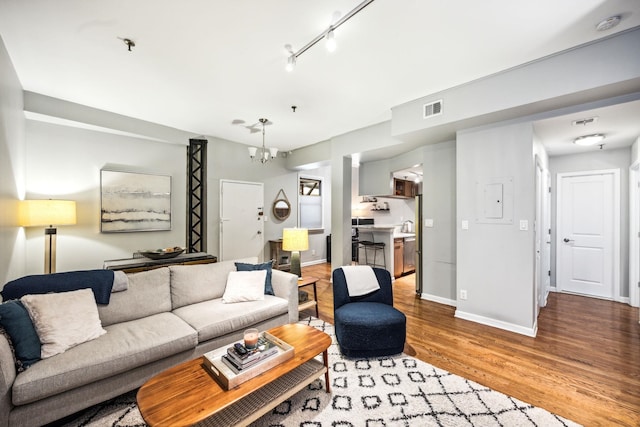 227 Christopher Columbus Dr Unit B-234, Jersey City, NJ 07302 - living area with wood finished floors, a chandelier, and electric panel
