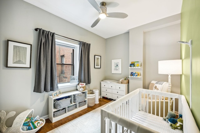 227 Christopher Columbus Dr Unit B-234, Jersey City, NJ 07302 - bedroom featuring a crib, wood finished floors, and a ceiling fan