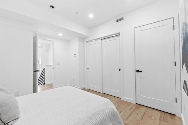 bedroom featuring recessed lighting, visible vents, and light wood-type flooring