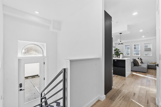 entryway featuring light wood-style flooring, recessed lighting, and baseboards