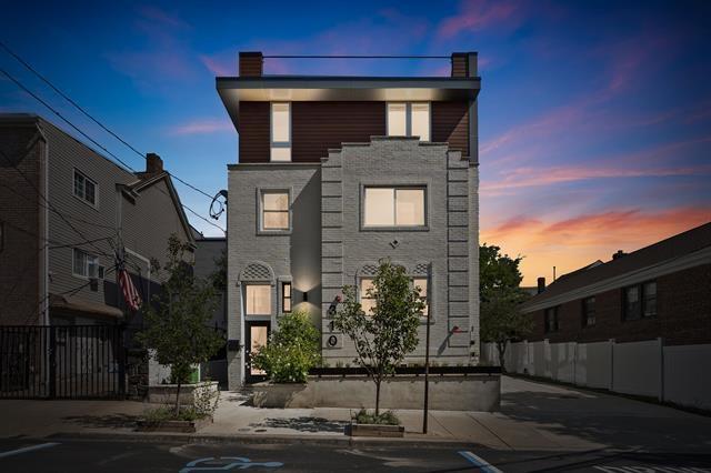 modern home with fence and a chimney