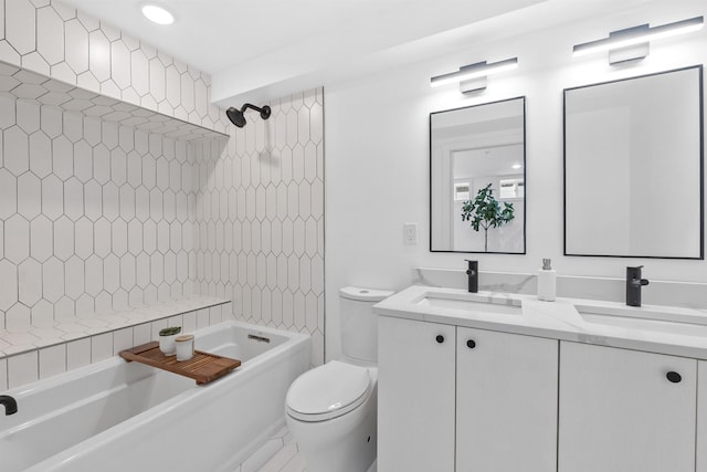 bathroom with a sink, toilet, double vanity, and bathing tub / shower combination