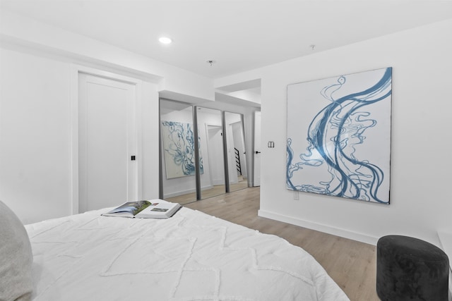 bedroom featuring recessed lighting, baseboards, and wood finished floors