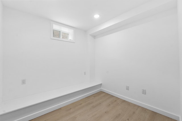 below grade area featuring recessed lighting, light wood-style flooring, and baseboards