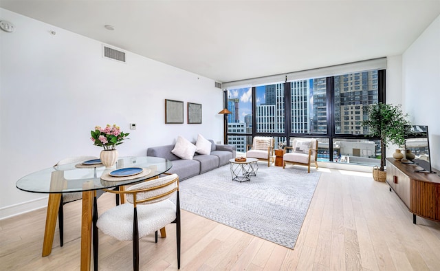 10 Provost St Unit 2405, Jersey City, NJ 07302 - living area featuring light wood-style floors and expansive windows