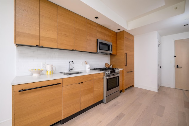 10 Provost St Unit 2405, Jersey City, NJ 07302 - kitchen with appliances with stainless steel finishes, light wood-style floors, decorative backsplash, light countertops, and recessed lighting