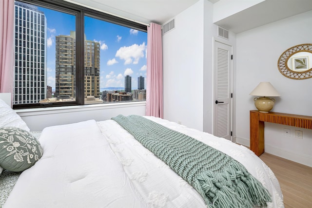 10 Provost St Unit 2405, Jersey City, NJ 07302 - bedroom featuring wood finished floors and a city view