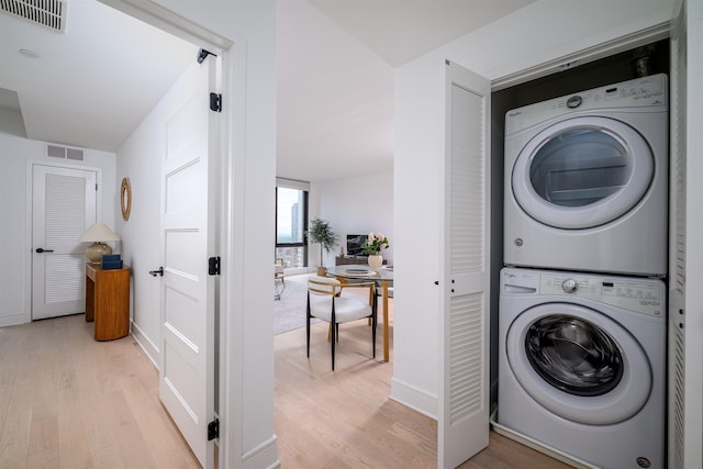 10 Provost St Unit 2405, Jersey City, NJ 07302 - laundry room featuring estacked washer and dryer and light wood finished floors