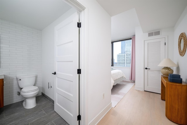 10 Provost St Unit 2405, Jersey City, NJ 07302 - bathroom with wood finished floors, tile walls, and vanity