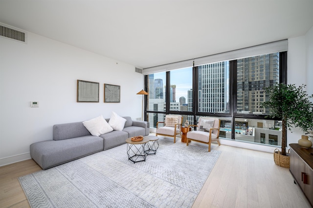 10 Provost St Unit 2405, Jersey City, NJ 07302 - living area featuring wood finished floors, expansive windows, and a city view