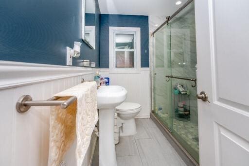 bathroom with toilet and walk in shower