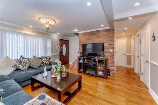 living room featuring light hardwood / wood-style flooring and ornamental molding