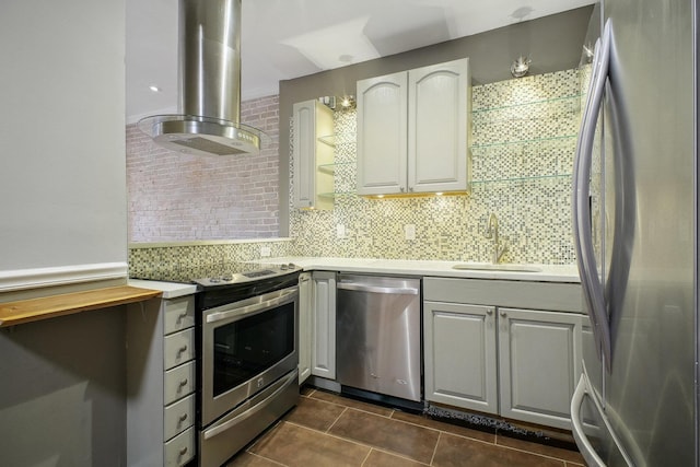 kitchen with backsplash, exhaust hood, dark tile patterned flooring, sink, and stainless steel appliances