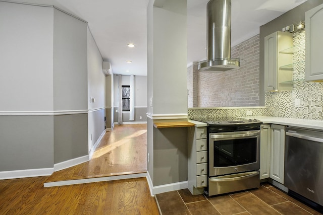 kitchen featuring decorative backsplash, appliances with stainless steel finishes, ventilation hood, and dark hardwood / wood-style floors