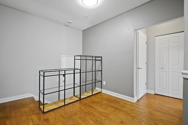 bedroom with hardwood / wood-style floors and a closet