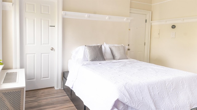 bedroom featuring visible vents and dark wood-style flooring