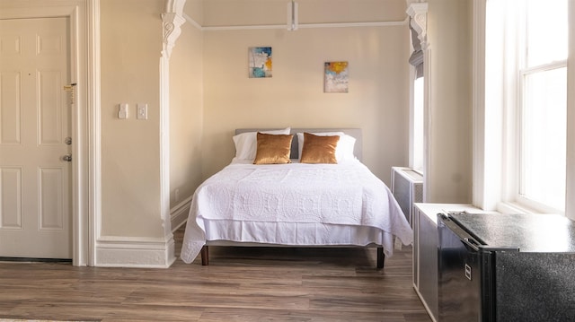 bedroom featuring dark wood-style floors and baseboards