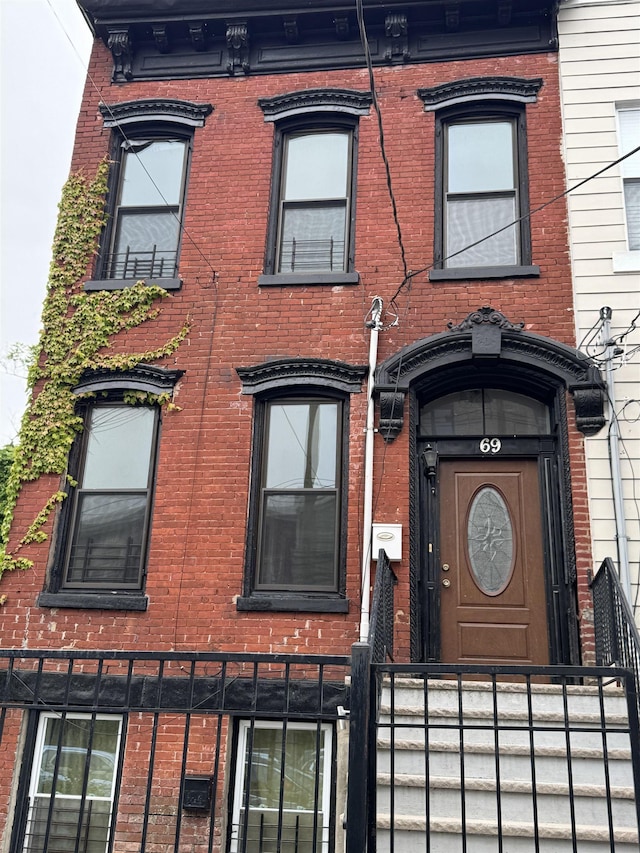 69 Jewett Ave, Jersey City, NJ 07304 - view of front of property featuring brick siding and a fenced front yard