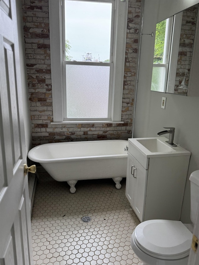69 Jewett Ave, Jersey City, NJ 07304 - bathroom featuring toilet, a freestanding bath, vanity, and tile patterned floors