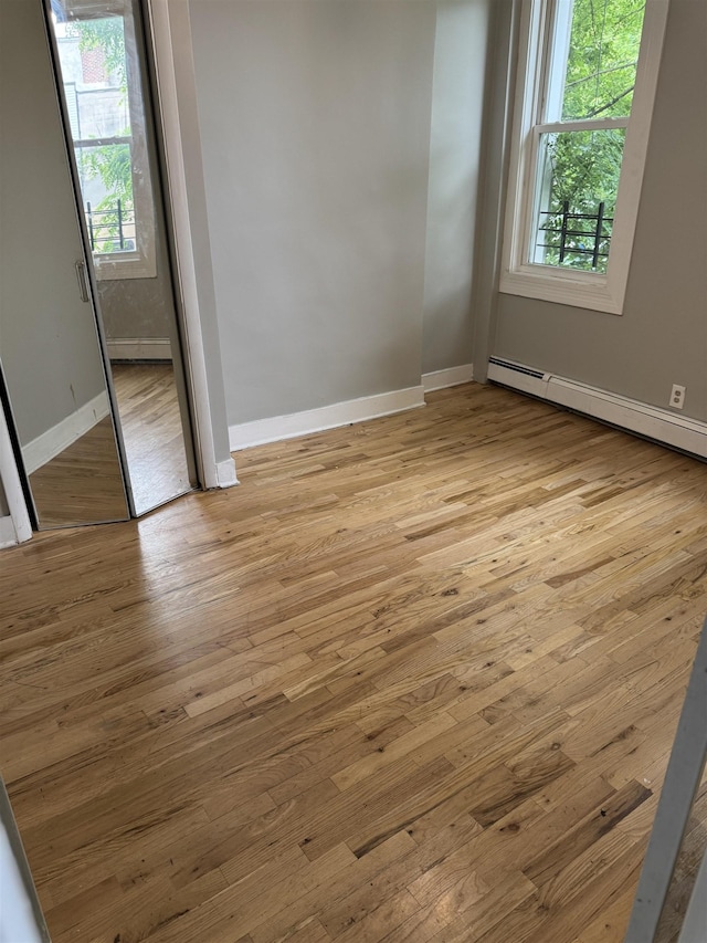 69 Jewett Ave, Jersey City, NJ 07304 - spare room featuring baseboards, light wood-style floors, and a baseboard radiator