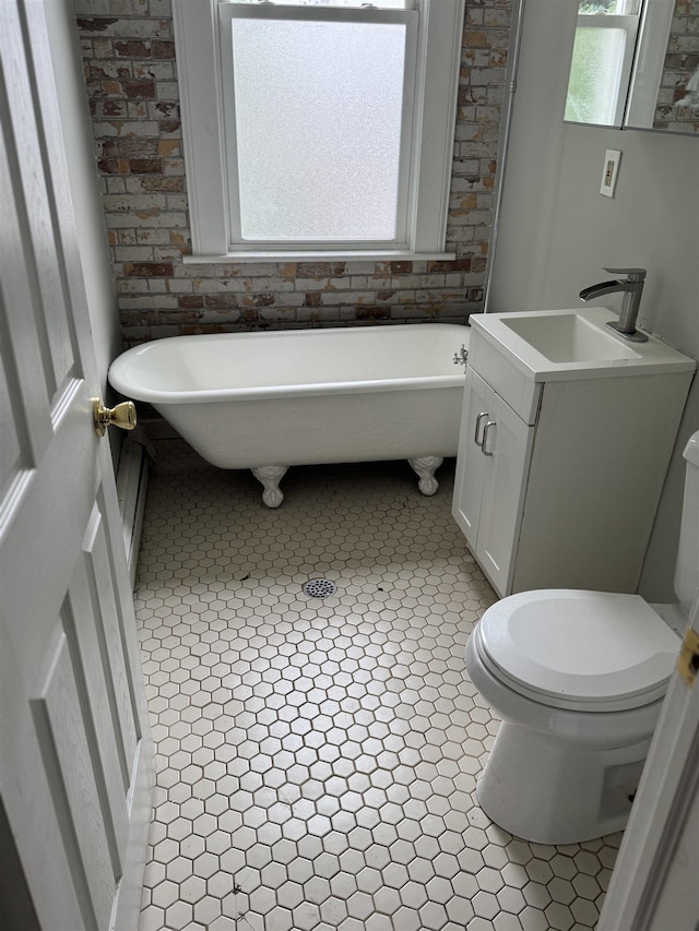 69 Jewett Ave, Jersey City, NJ 07304 - bathroom with a soaking tub, toilet, vanity, and tile patterned floors