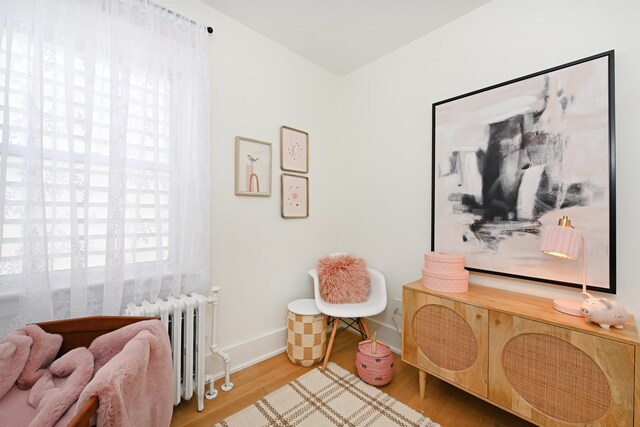 372 Webster Ave, Jersey City, NJ 07307 - living area featuring radiator heating unit and wood finished floors