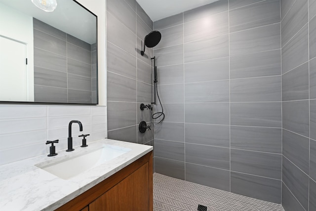 372 Webster Ave, Jersey City, NJ 07307 - bathroom with a tile shower, vanity, tile walls, and decorative backsplash