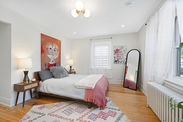 372 Webster Ave, Jersey City, NJ 07307 - bedroom with radiator heating unit, light wood finished floors, and multiple windows