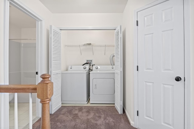 laundry room featuring baseboards, laundry area, light carpet, and washer and clothes dryer