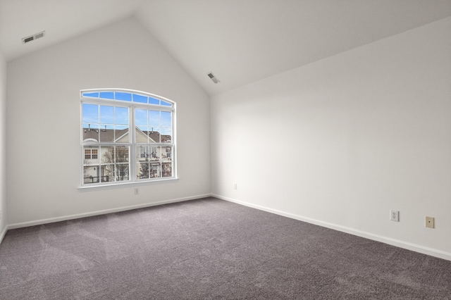 empty room featuring baseboards, dark colored carpet, visible vents, and high vaulted ceiling