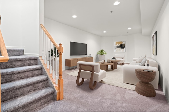 carpeted living room with recessed lighting, stairway, and baseboards