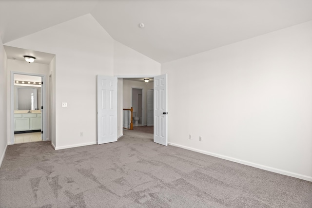 unfurnished bedroom with baseboards, carpet, and high vaulted ceiling