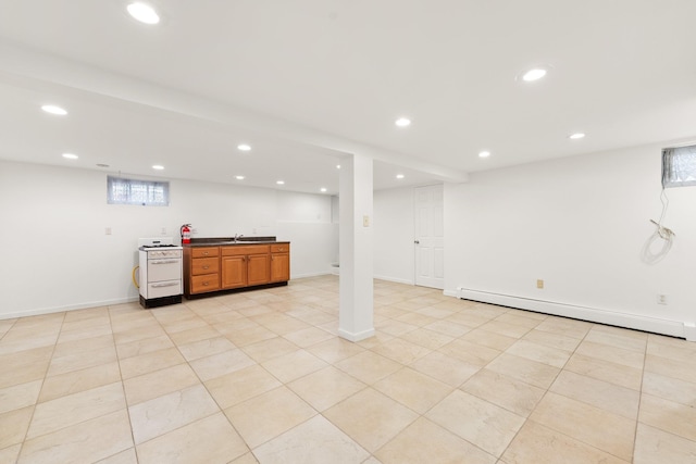 basement featuring light tile patterned floors and a baseboard radiator