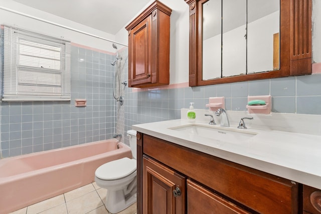 full bathroom featuring tasteful backsplash, vanity, tile patterned flooring, toilet, and tiled shower / bath