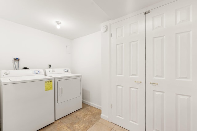 laundry room featuring independent washer and dryer and light tile patterned floors