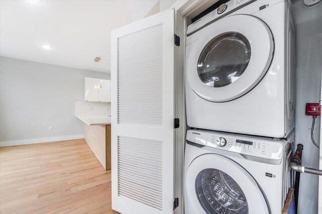 443 Bergen Ave Unit C3, Jersey City, NJ 07304 - laundry area featuring light wood-style flooring, laundry area, stacked washing maching and dryer, baseboards, and recessed lighting