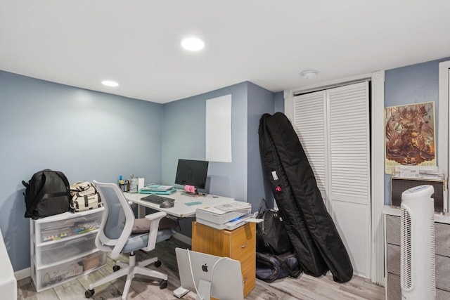 home office with light hardwood / wood-style flooring