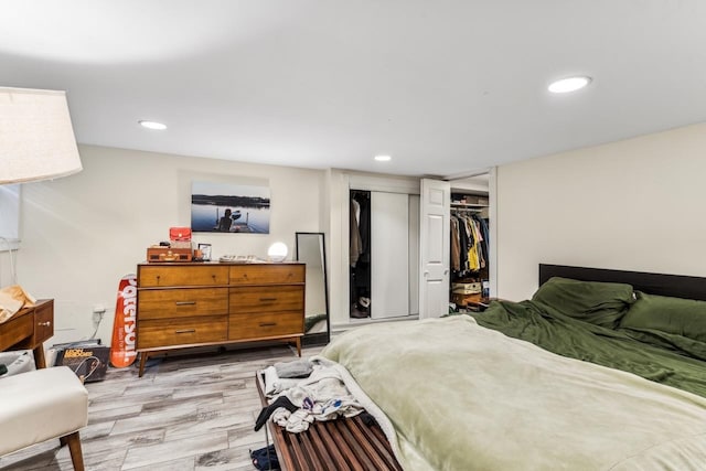 bedroom with a closet and light hardwood / wood-style flooring