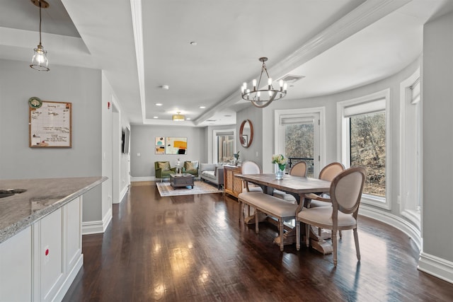 dining room with a raised ceiling, visible vents, baseboards, a chandelier, and dark wood-style flooring