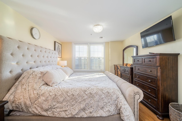 bedroom with visible vents and light wood-style floors