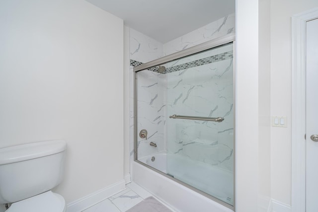 full bathroom with toilet, baseboards, marble finish floor, and enclosed tub / shower combo