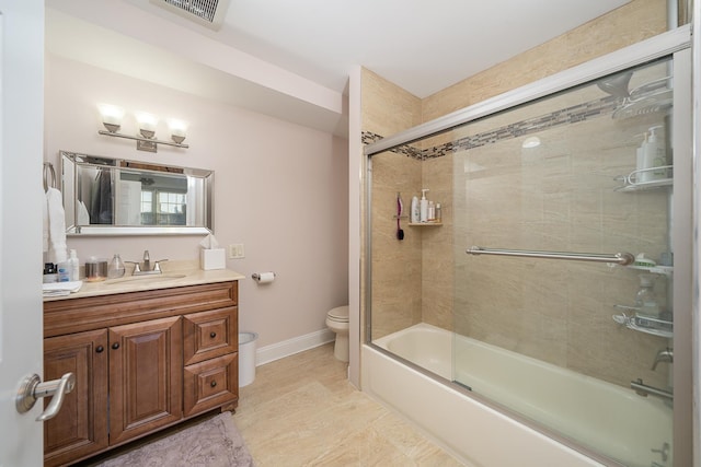 full bathroom featuring vanity, baseboards, toilet, visible vents, and bath / shower combo with glass door
