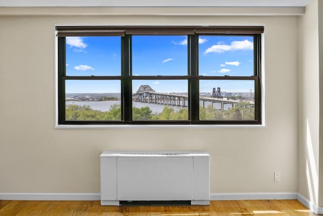 1225 Kennedy Blvd Unit 7C, Bayonne, NJ 07002 - empty room featuring baseboards, radiator heating unit, wood finished floors, and healthy amount of natural light