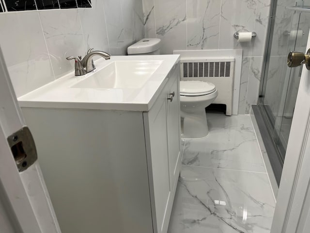 bathroom featuring vanity, radiator heating unit, and a shower