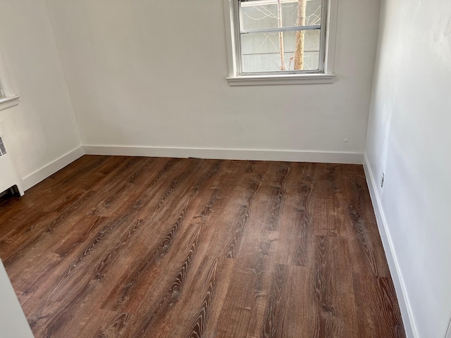 spare room featuring dark hardwood / wood-style flooring