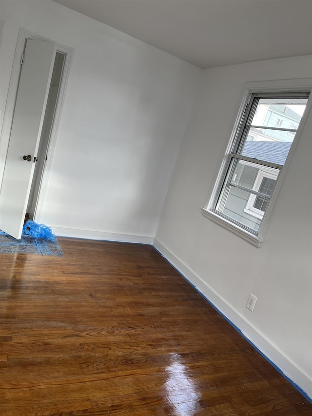 spare room with dark wood-type flooring