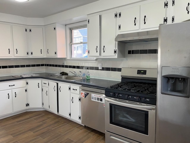 kitchen featuring sink, tasteful backsplash, dark hardwood / wood-style flooring, stainless steel appliances, and white cabinets